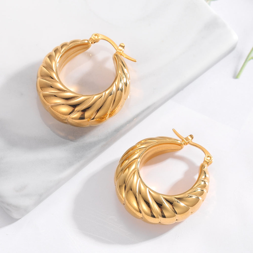 Glamorous Caitlyn Retro Hoop Earrings in gold with intricate detailing. Elevate your outfit with these statement hoops.