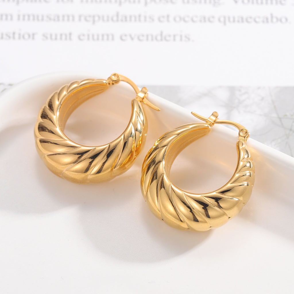 Glamorous Caitlyn Retro Hoop Earrings in gold with intricate detailing. Elevate your outfit with these statement hoops.