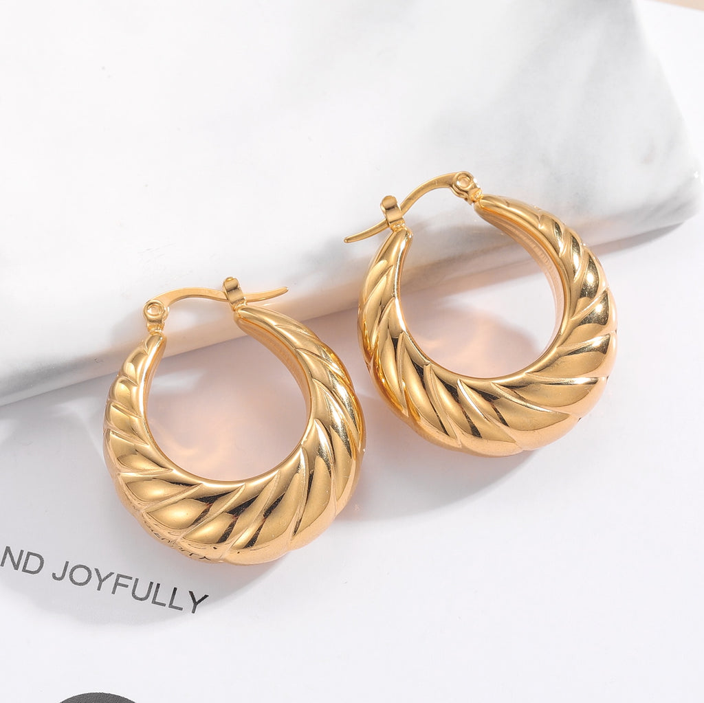 Glamorous Caitlyn Retro Hoop Earrings in gold with intricate detailing. Elevate your outfit with these statement hoops.