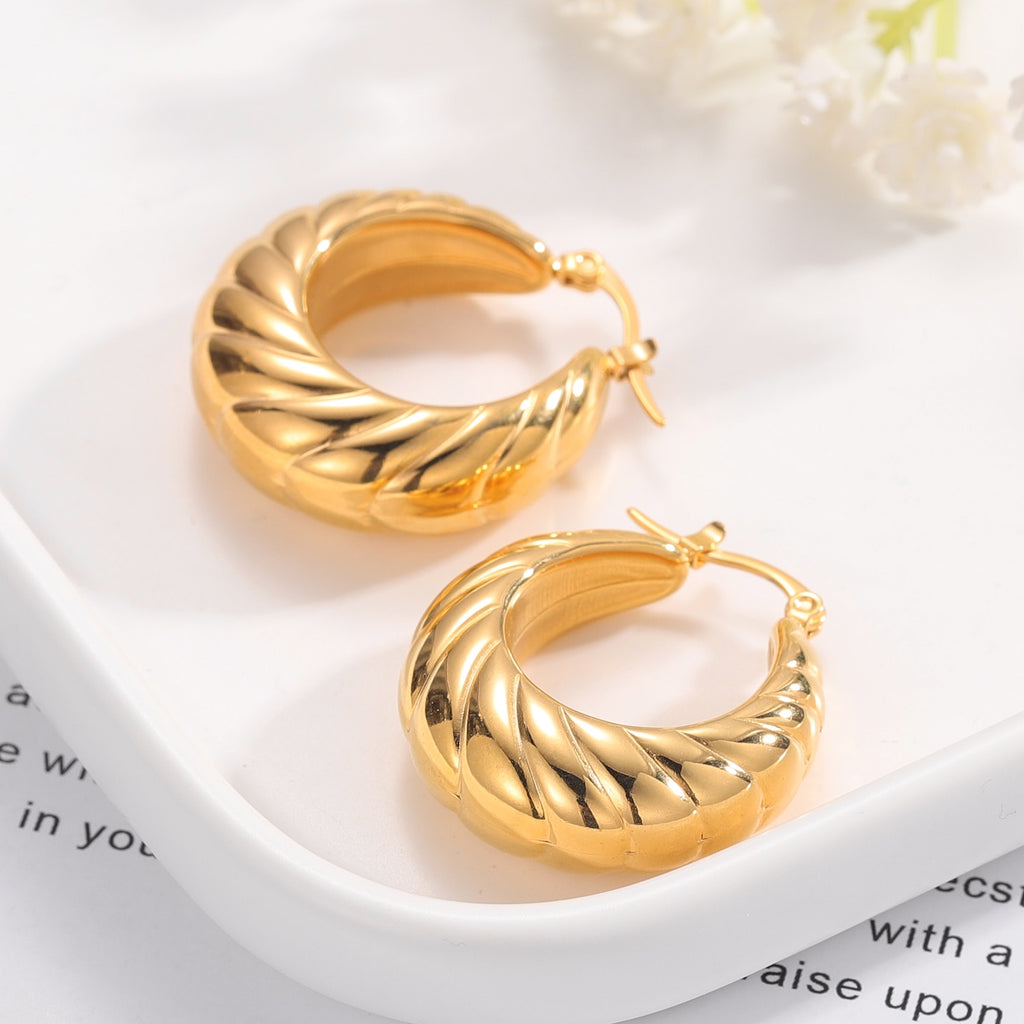 Glamorous Caitlyn Retro Hoop Earrings in gold with intricate detailing. Elevate your outfit with these statement hoops.