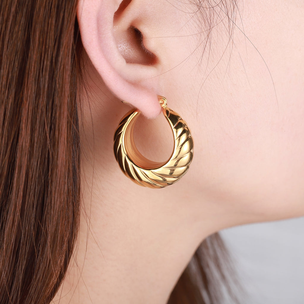 Glamorous Caitlyn Retro Hoop Earrings in gold with intricate detailing. Elevate your outfit with these statement hoops.