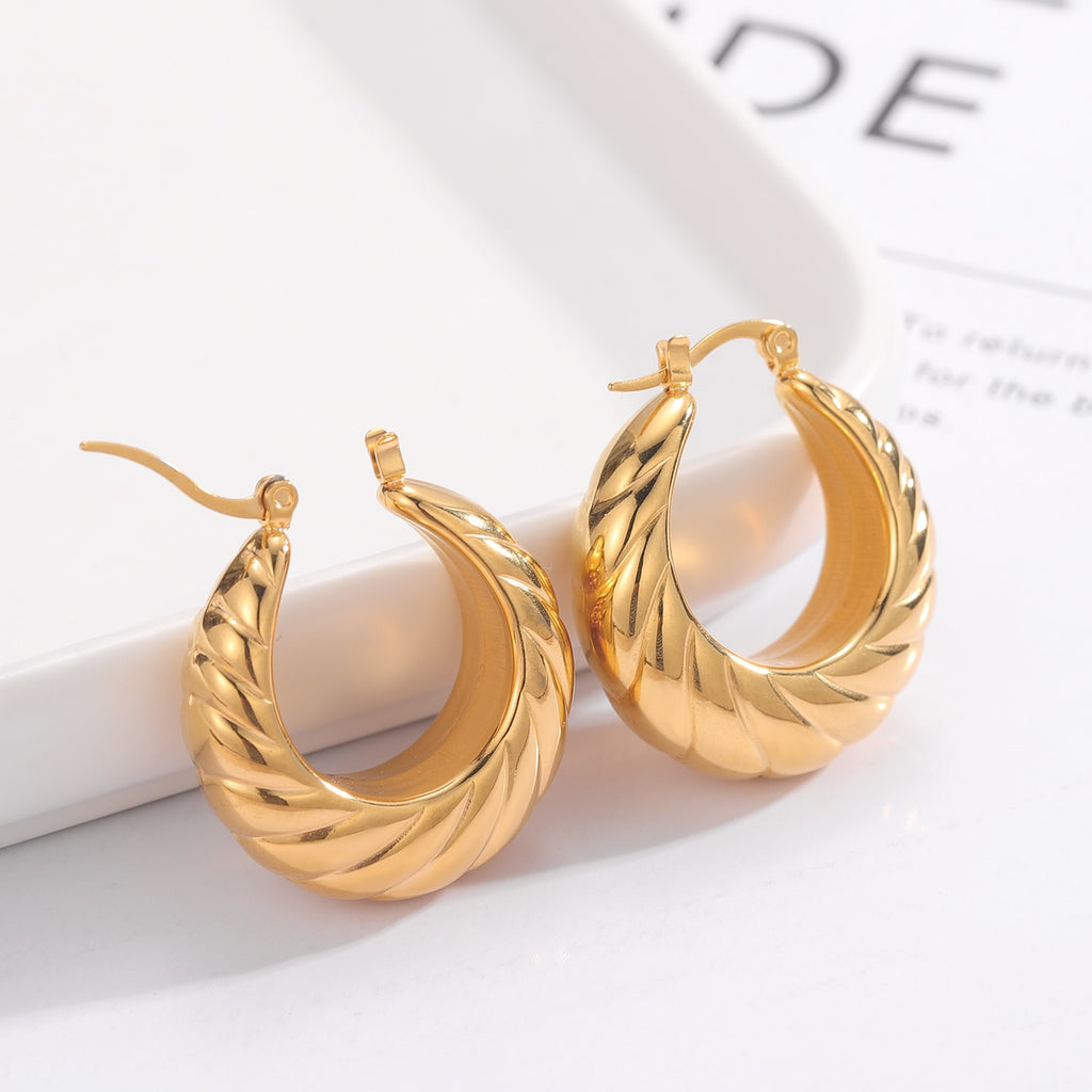 Glamorous Caitlyn Retro Hoop Earrings in gold with intricate detailing. Elevate your outfit with these statement hoops.