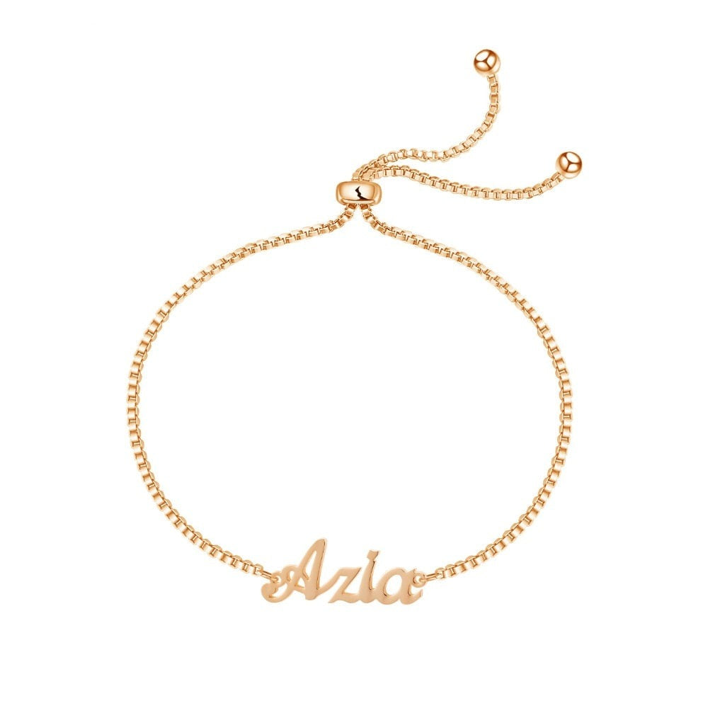 A delicate Rose Gold bracelet with small name charms hanging from it. The name charms are customizable with your own choice of letters and font styles, making it a perfect personalized accessory