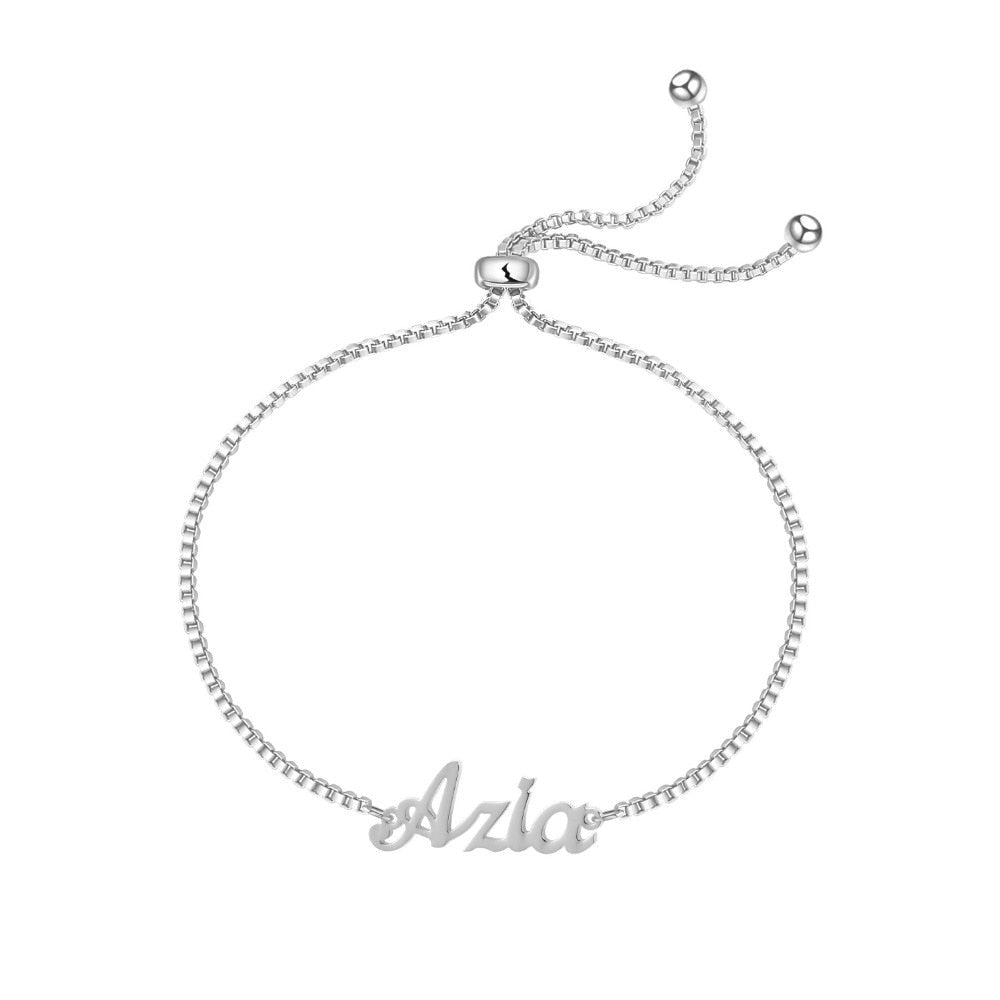 A delicate silver bracelet with small name charms hanging from it. The name charms are customizable with your own choice of letters and font styles, making it a perfect personalized accessory